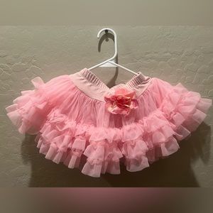 Girls light pink, fluffy tutu will fit  1 to 3 year old with flower in the front